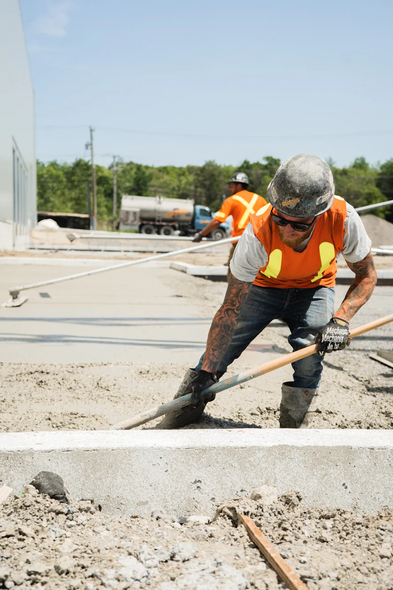 Finisher working fresh concrete level