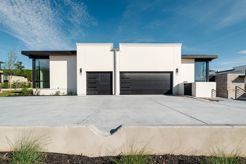 Finished concrete driveway and three-car garage